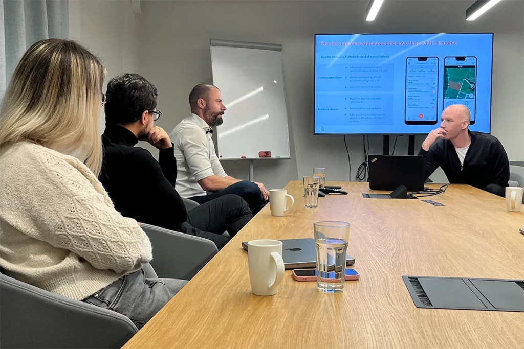 A team of Black Label and Farmable team members discussing strategies.